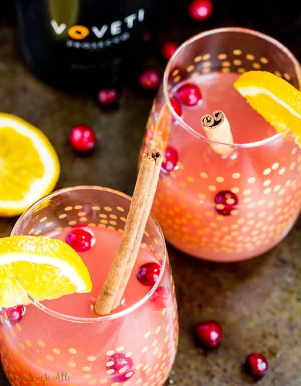 cranberry orange mimosa drink with fresh cranberry and orange slices