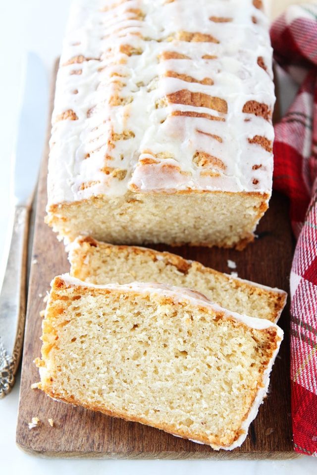 sliced eggnog bread with a glaze drizzled over the top