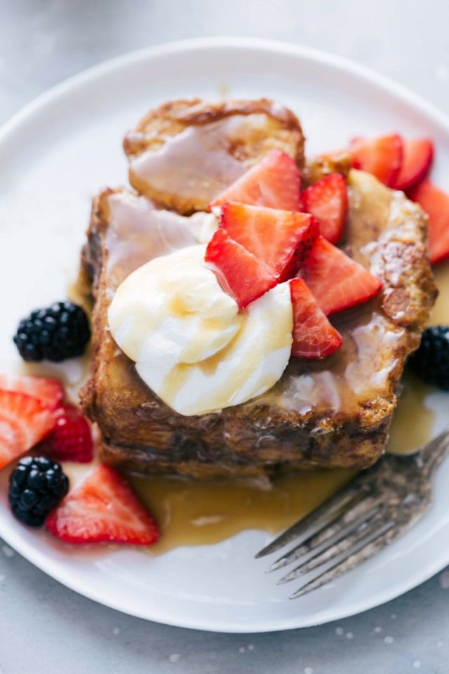 best French toast topped with syrup and berries 