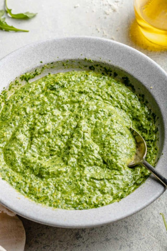 mixing pesto with parmesan cheese and lemon zest