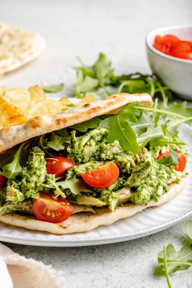 pesto chicken salad served with cherry tomatoes in a pita