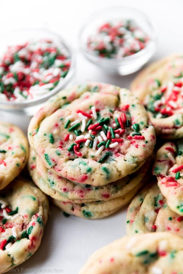 Christmas Sugar Cookies stacked up and topped with green and red sprinkles