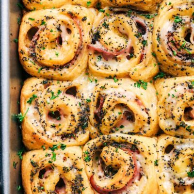 Ham and Swiss pinwheel rolls in a pan.
