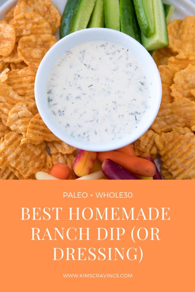 Ranch dip in a small white bowl served with chips and veggies