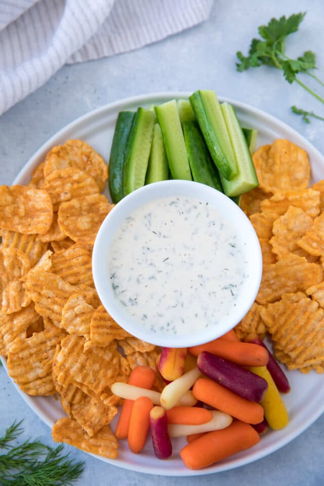 Ranch dip served with baby carrots, cucumber sticks and chips