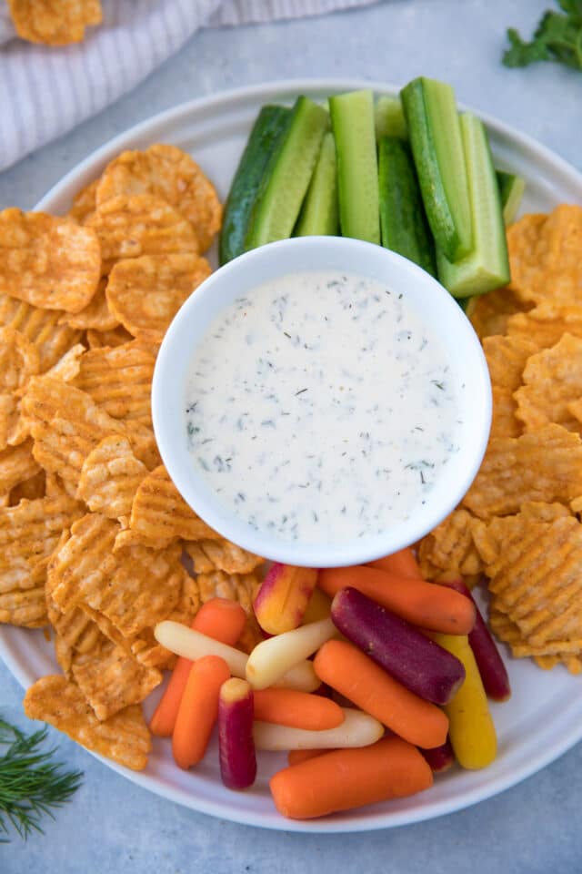 small bowl of ranch dip in the center of an appetizer platter