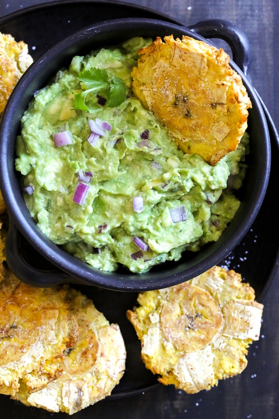 Tostones dipped in guacamole 