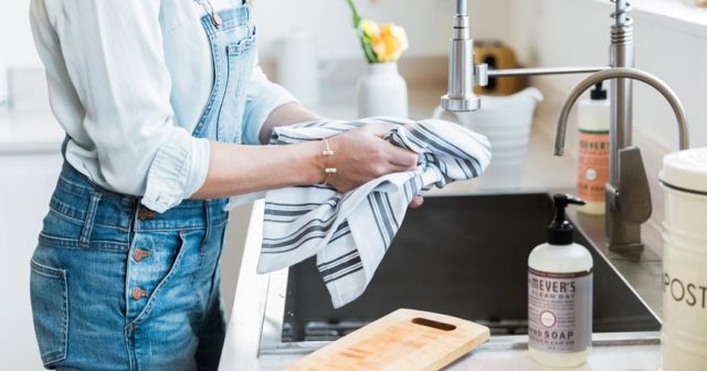 woman at sink with dishtowel 