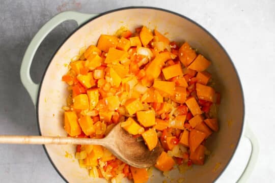 Cooking cubed sweet potato in a large pot.