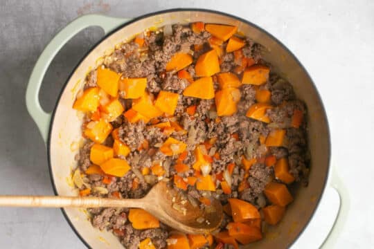 Browning ground beef with sweet potato.