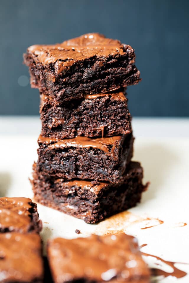 four fudgy brownies stacked on top of one another