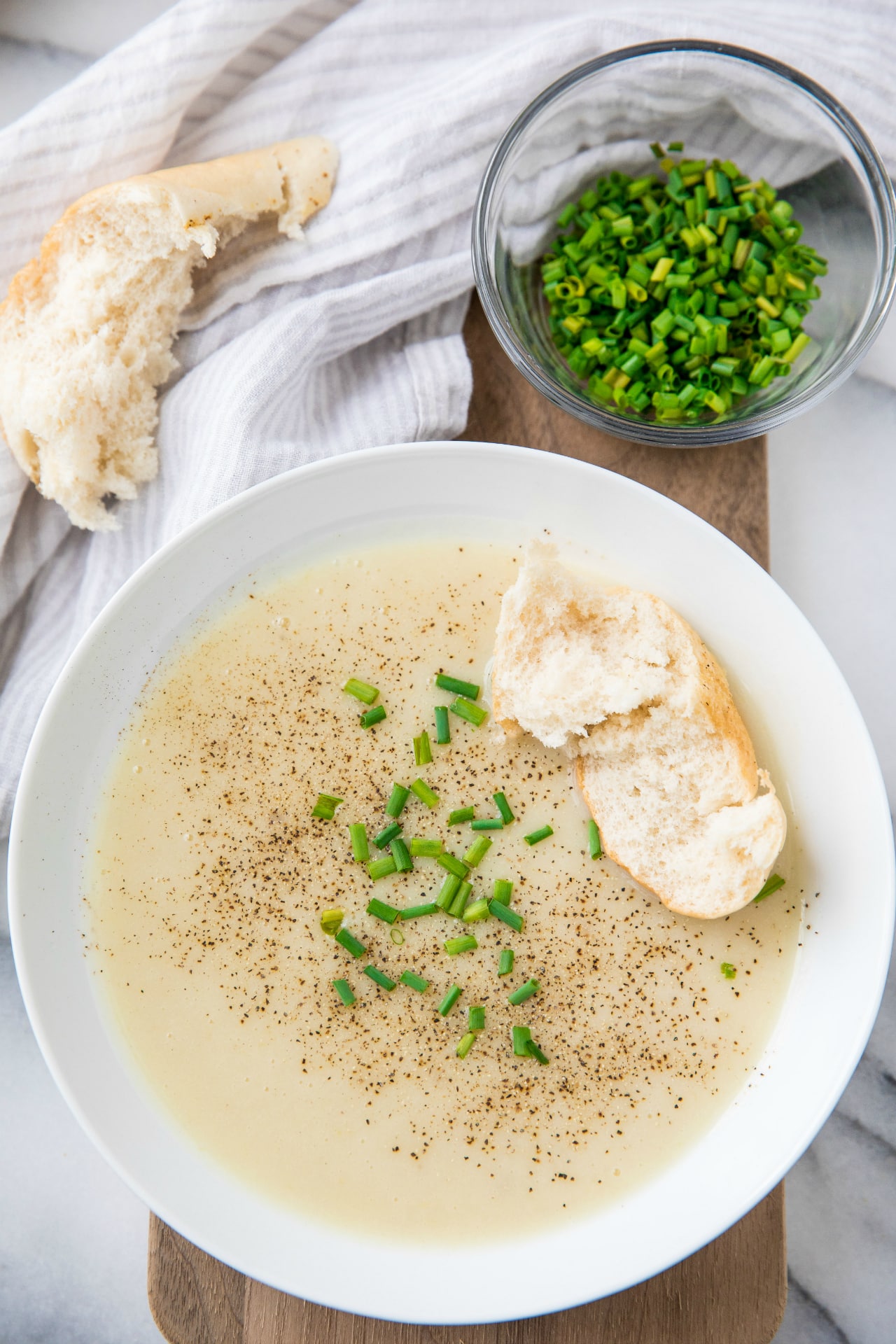 creamy soup served with bread in a white bowl