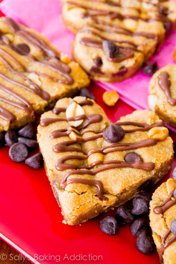 heart-shaped blondies topped with chocolate chips and chocolate drizzle