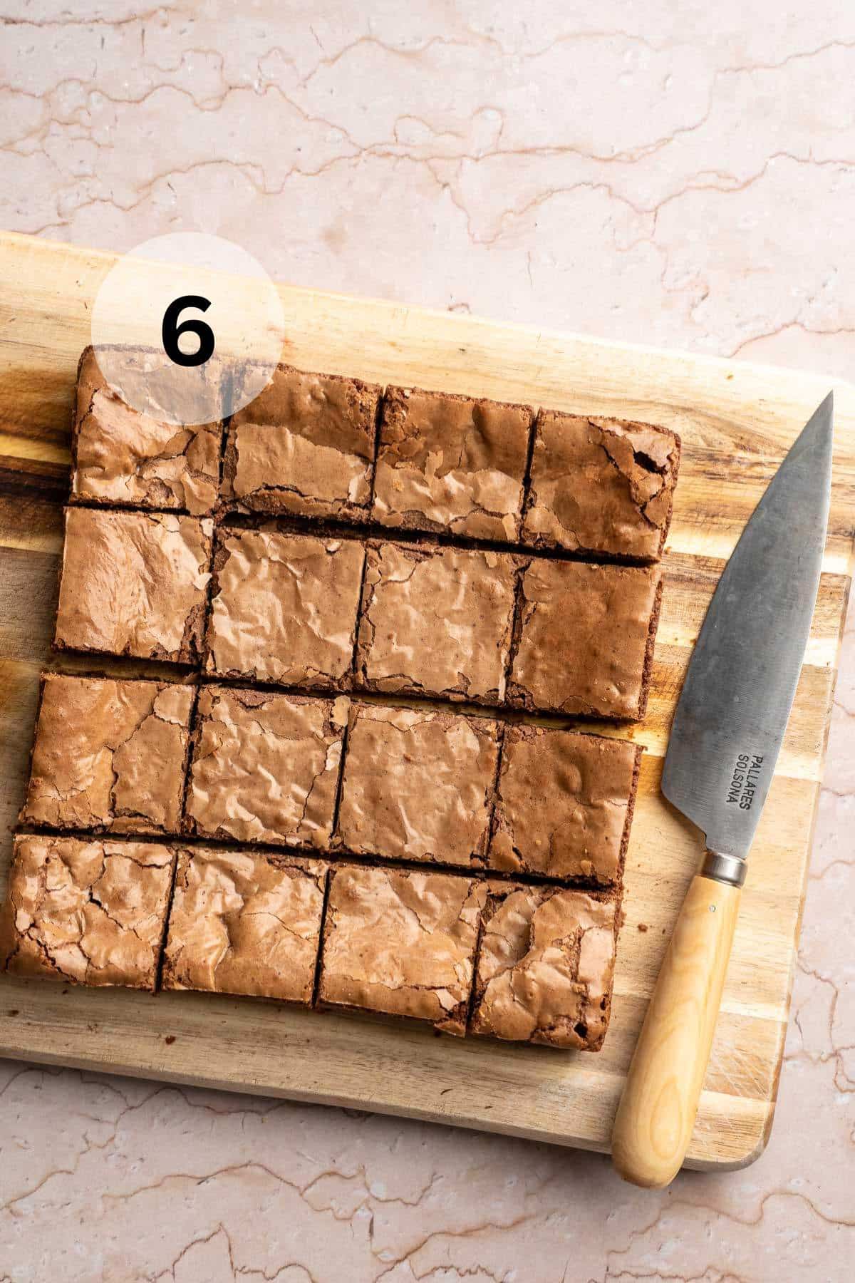 Brownies on a cutting board cut into squares.