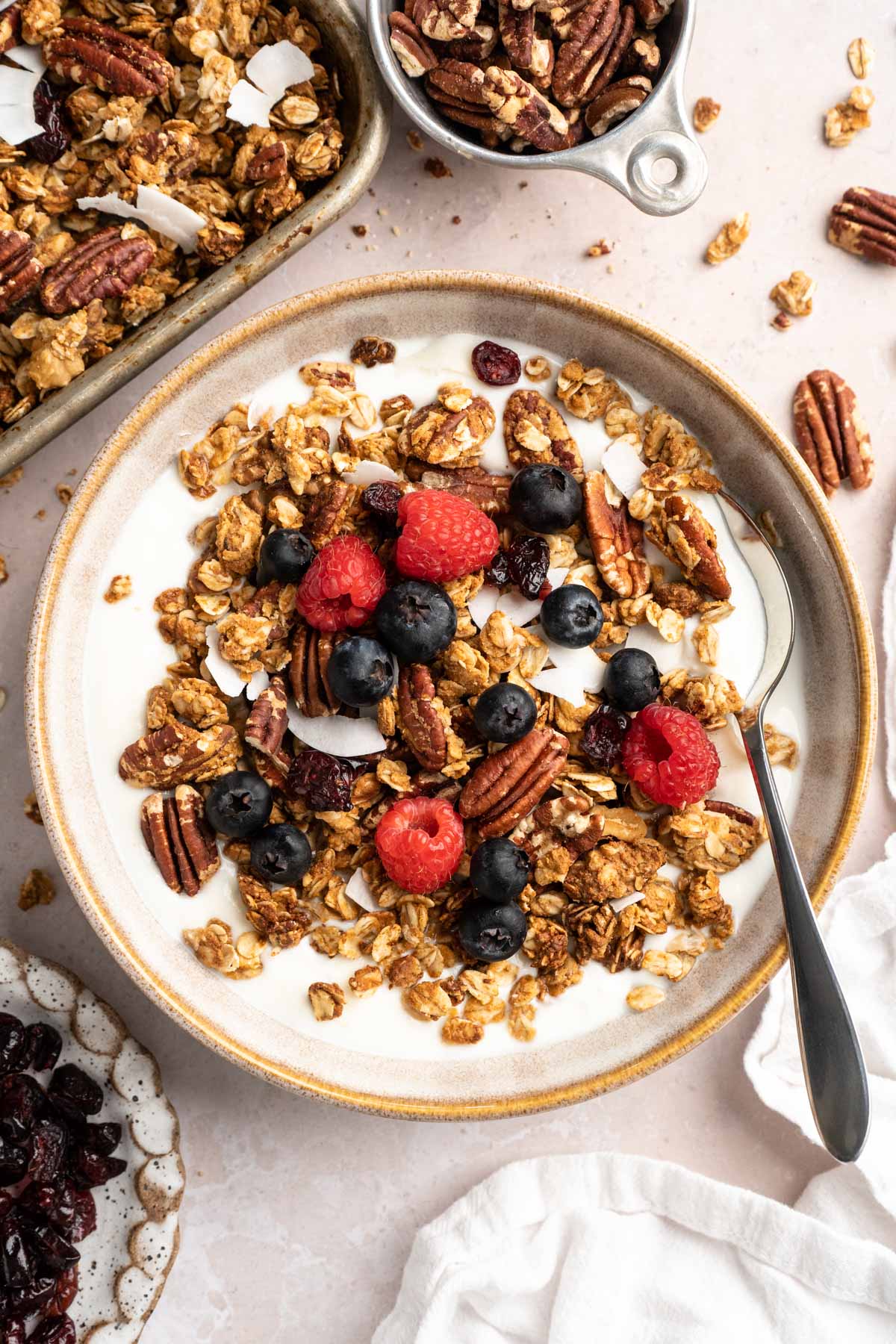 Bowl of milk with protein granola and berries.