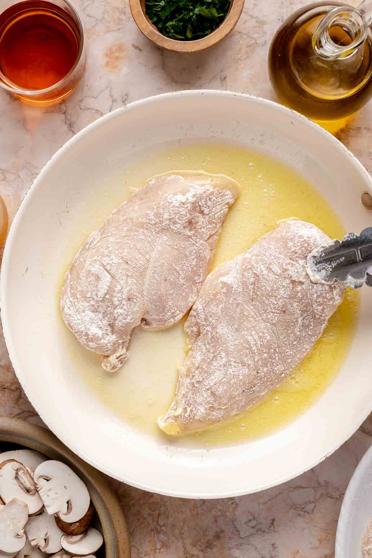 Cooking chicken in a skillet.