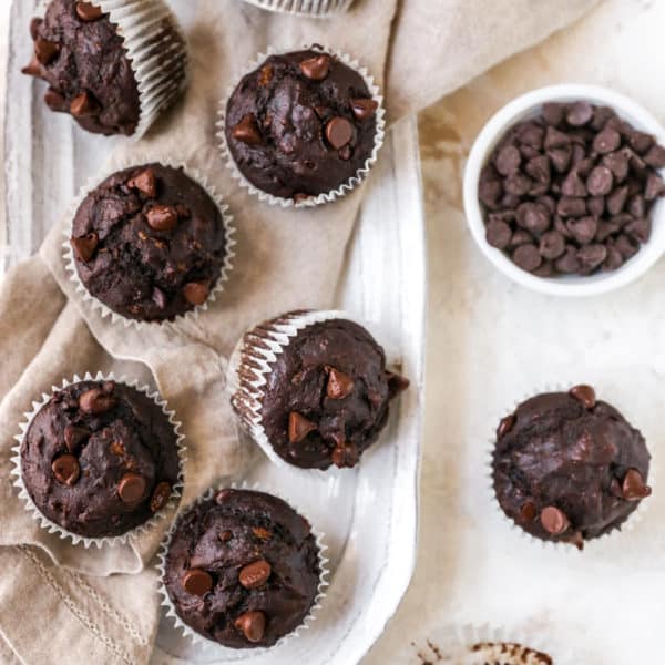 double chocolate banana muffins near a bowl filled with chocolate chips