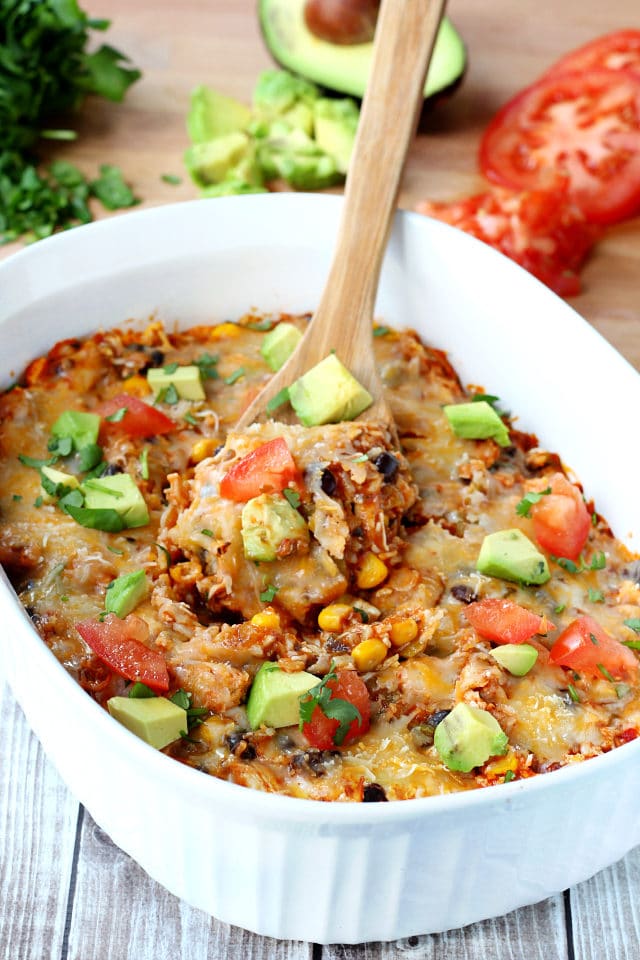 enchilada casserole with wooden spoon 