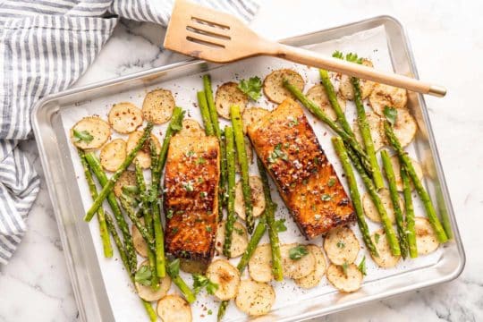 salmon on a pan with asparagus and potatoes