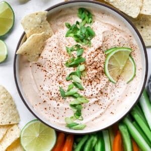 chipotle ranch dressing topped with green onion and lime