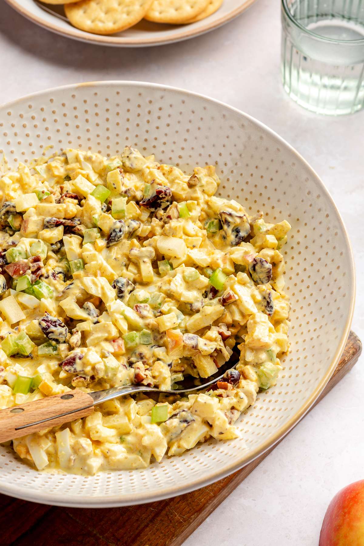 Stirring curried egg salad with a spoon.
