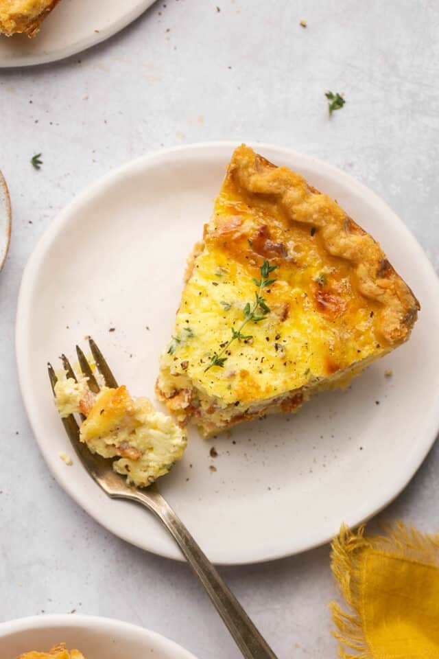 Quiche on a plate with some on a fork.