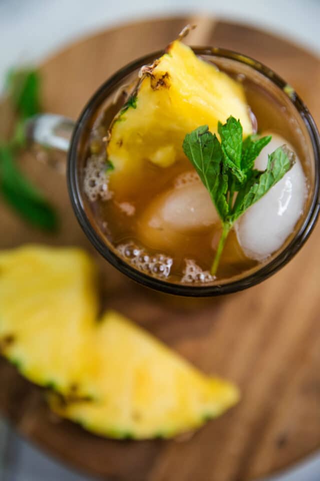 Pineapple Sweet Tea with a chunk of pineapple and fresh mint