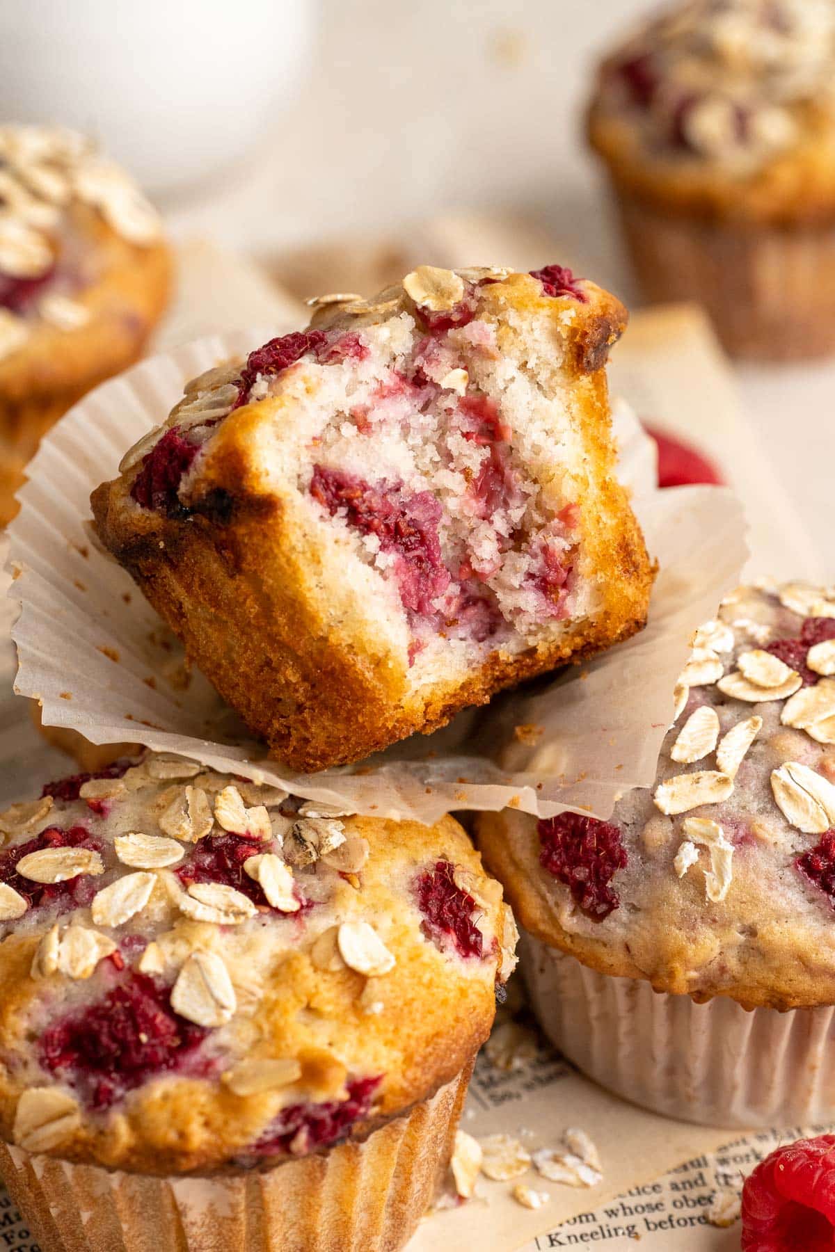 A bite taken out of a raspberry muffin.
