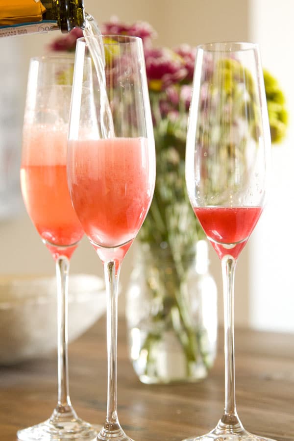 Blood Orange Mimosas poured in champagne glasses
