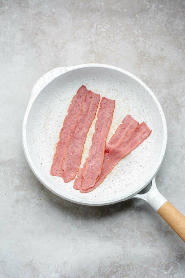 Cooking bacon in a skillet.