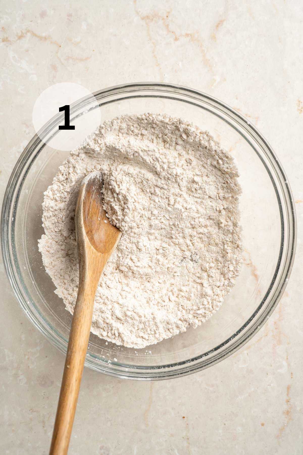 Stirring flour mixture with a wooden spoon.