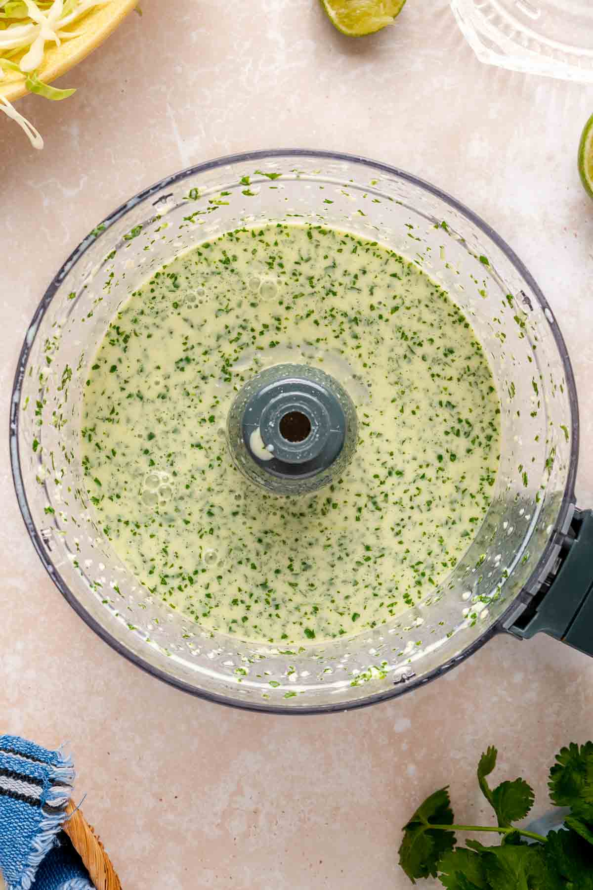 Creamy green sauce in a food processor.