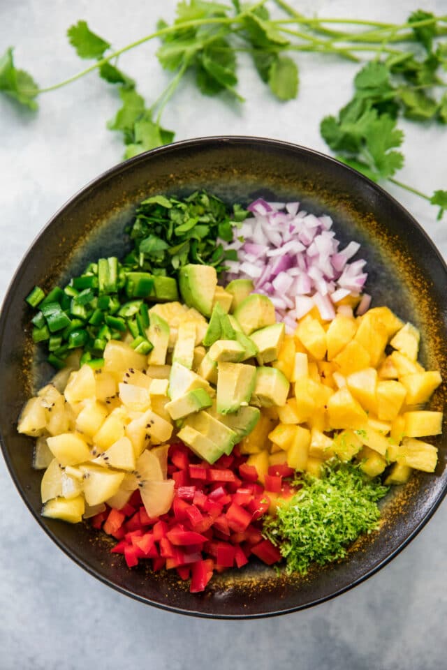 pineapple, kiwi and avocado in a bowl for salsa