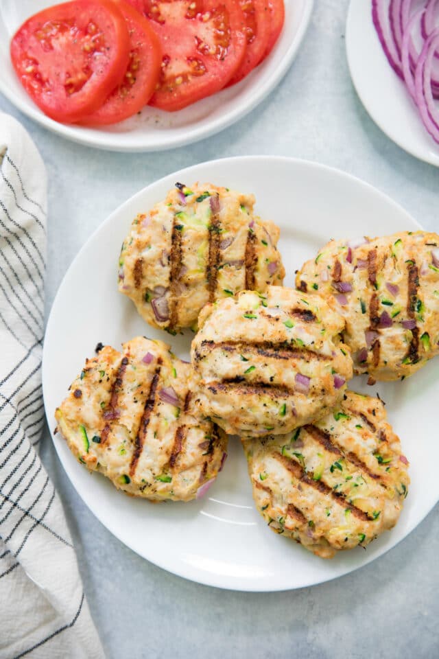 Zucchini Turkey Burger patties with grill marks on a white plate