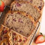 Sliced strawberry banana bread on a wire rack.