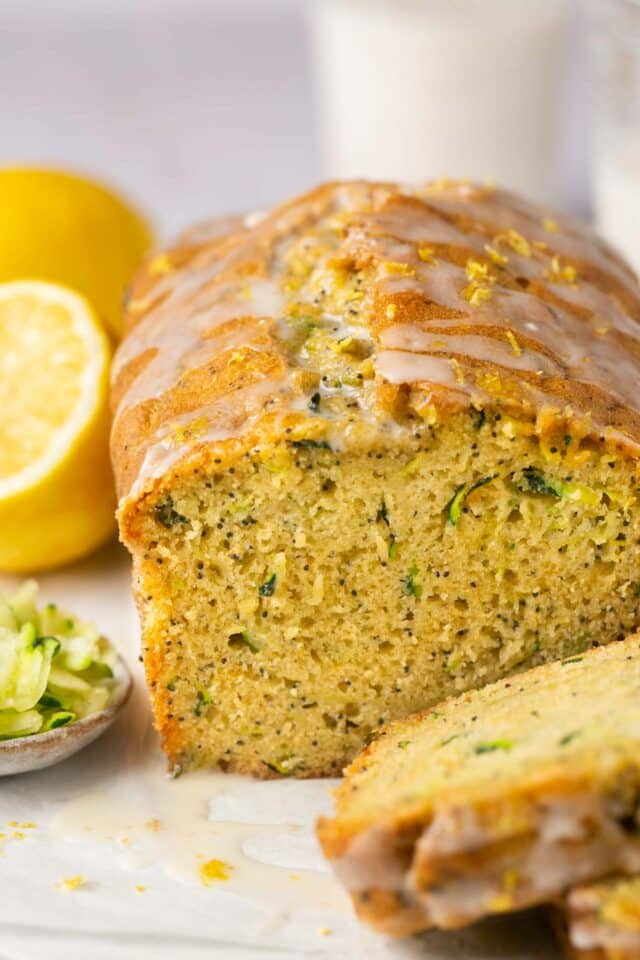 Loaf of lemon zucchini bread topped with glaze.