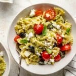 Pesto pasta tossed with cherry tomatoes and black olives.