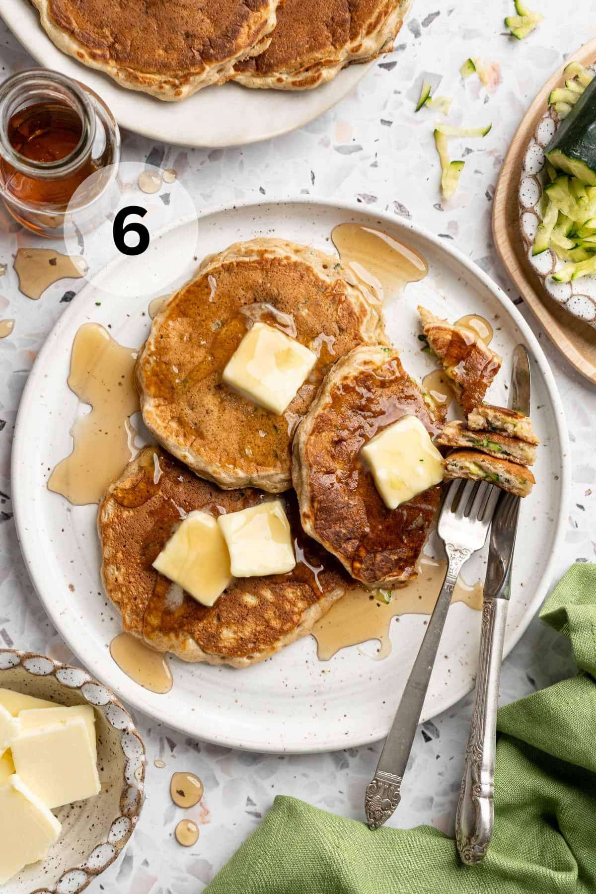 Pancakes topped with butter and syrup.
