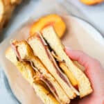 hand holding Peach Ham Grilled Cheese Sandwich