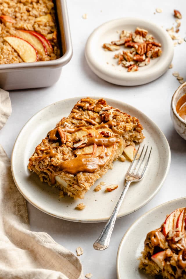 apple cinnamon baked oatmeal on a white plate with a fork