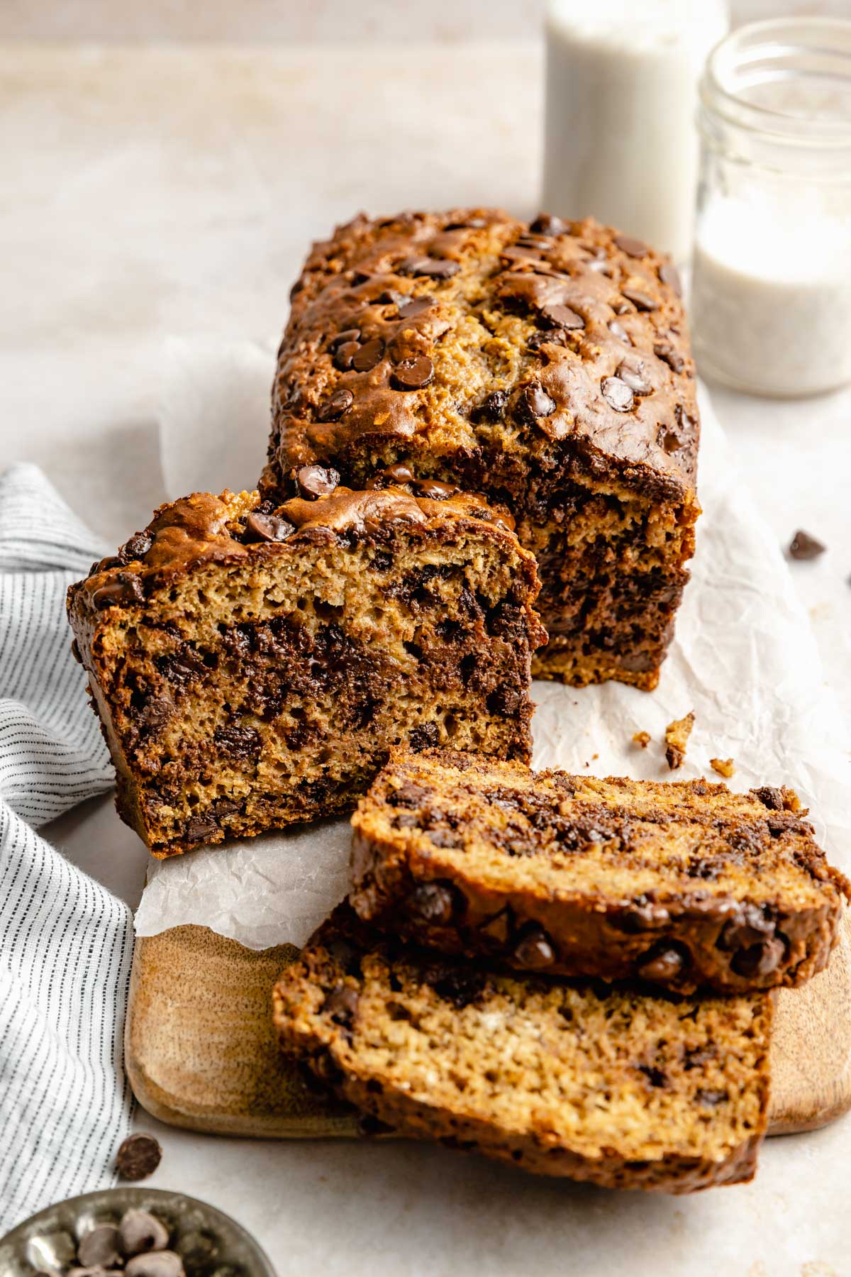 Banana bread with chocolate chips sliced on a cutting board.
