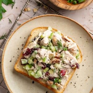 Honey mustard chicken salad served on a slice of bread.