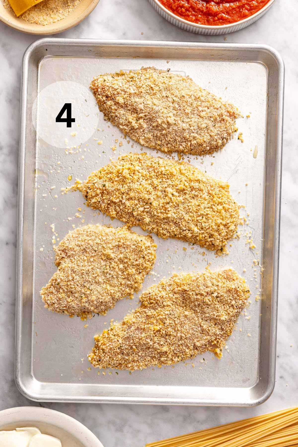 Breaded chicken on a sheet pan.