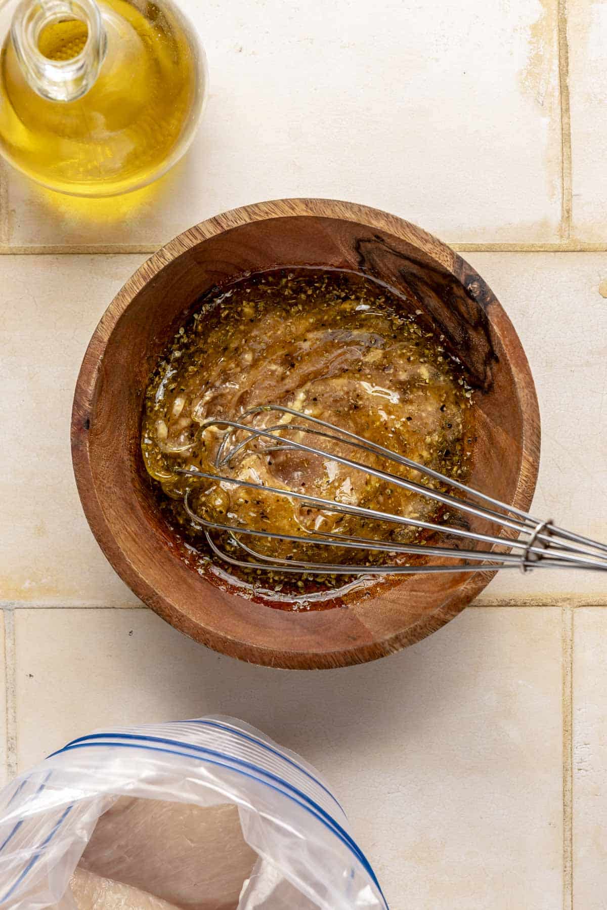 Whisking a marinade in a small bowl.