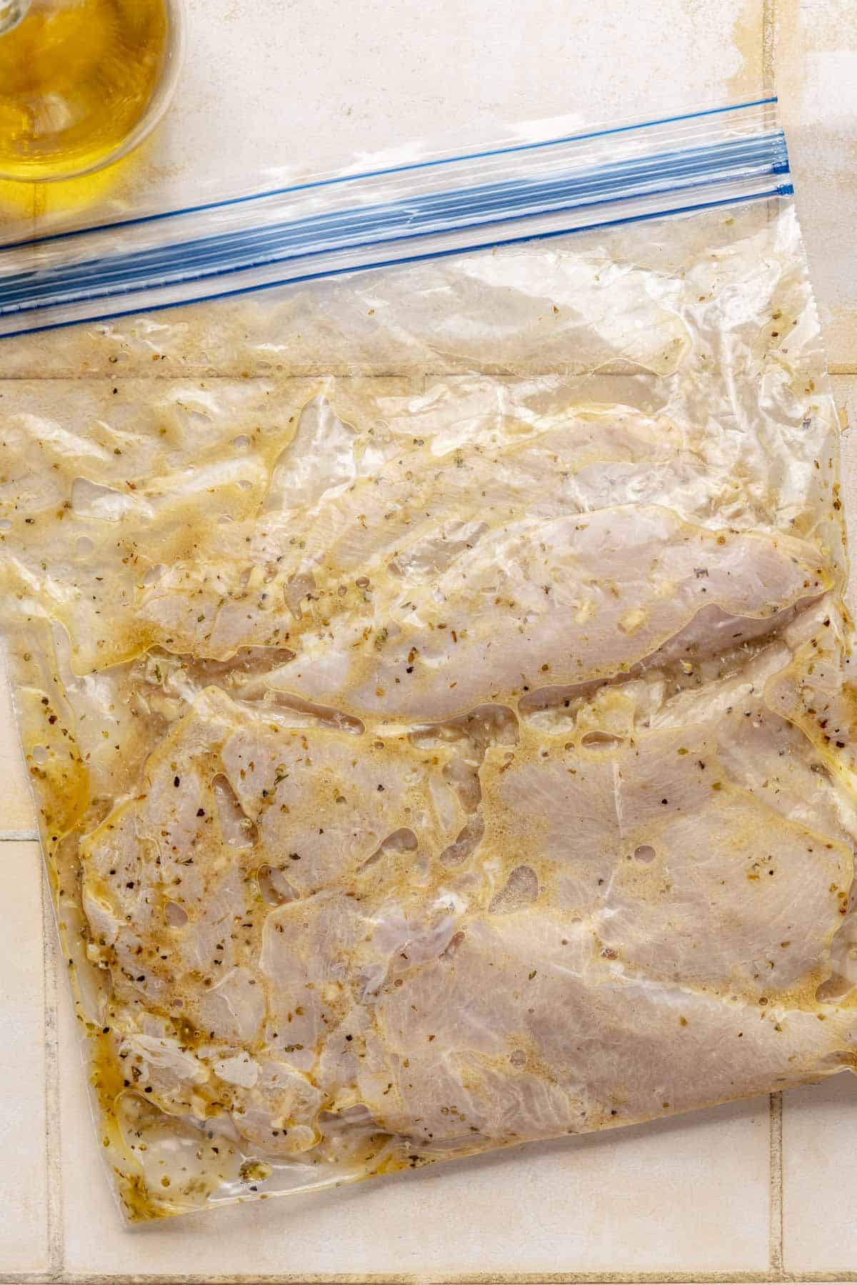 Chicken marinating in a ziplock bag.