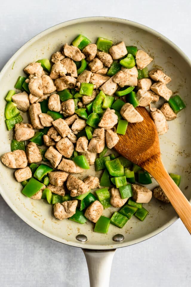 cook chicken and green bell pepper in a large skillet
