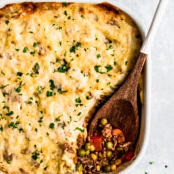 Shepherd's Pie in a white baking dish with a wooden spoon