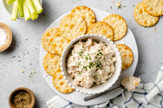 Serving tuna salad with crackers on a plate.