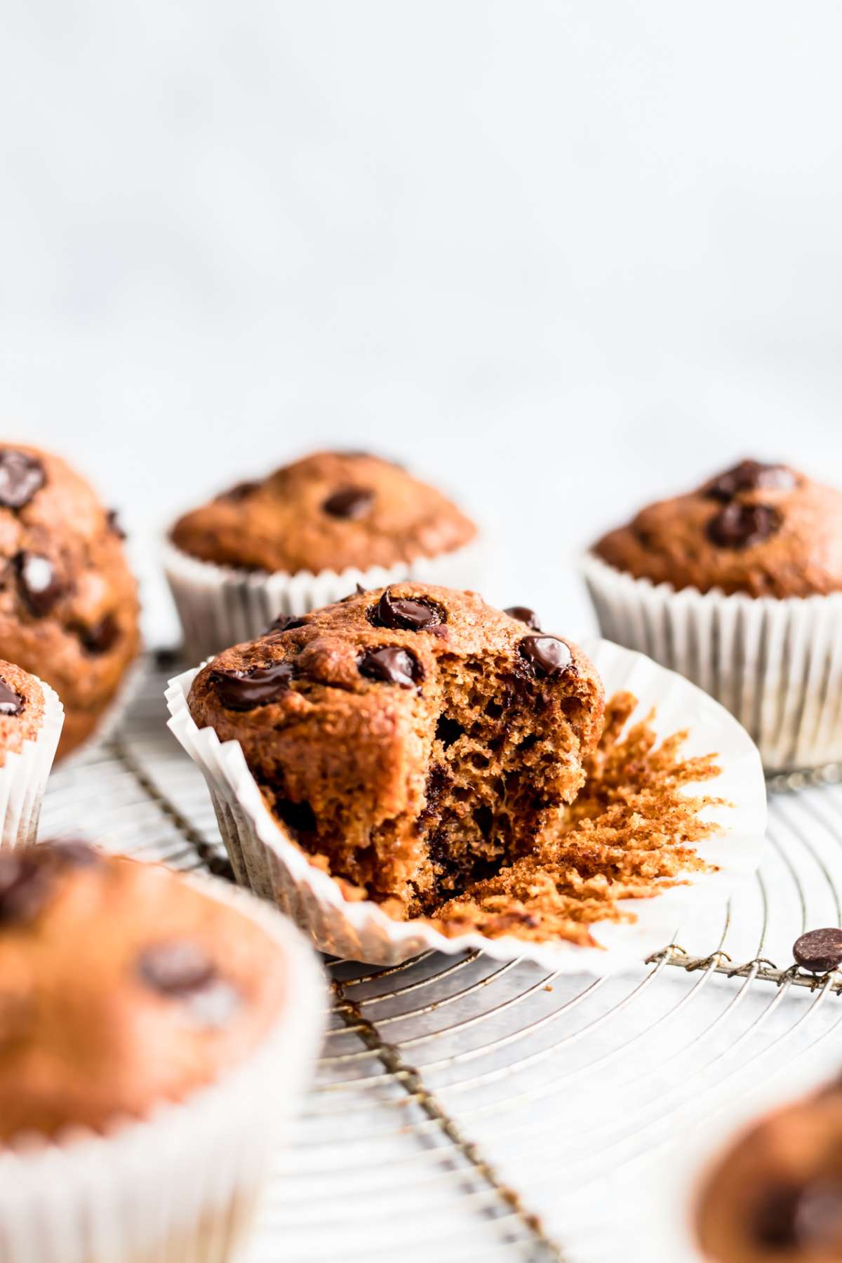 Chocolate chip muffin that has been bitten into.