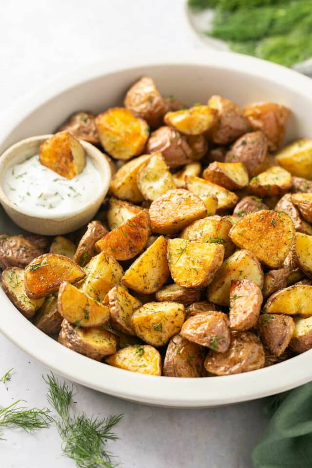 Baby potatoes in a bowl with ranch dressing.